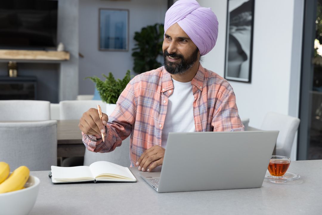Man in Lavender Turban Writing at Modern Home Workspace