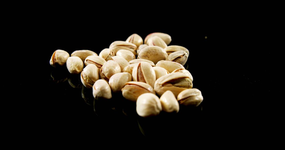 Pile of Pistachio Nuts on Black Background - Free Images, Stock Photos and Pictures on Pikwizard.com