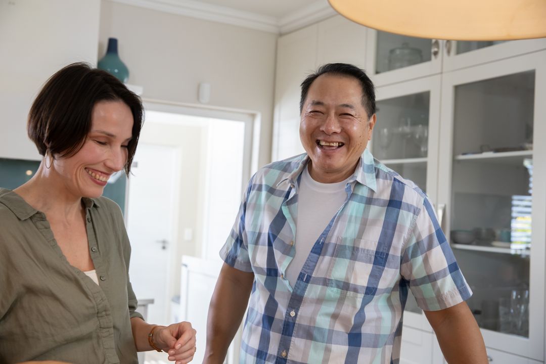 Senior Couple Enjoying Time Together in Modern Kitchen at Home