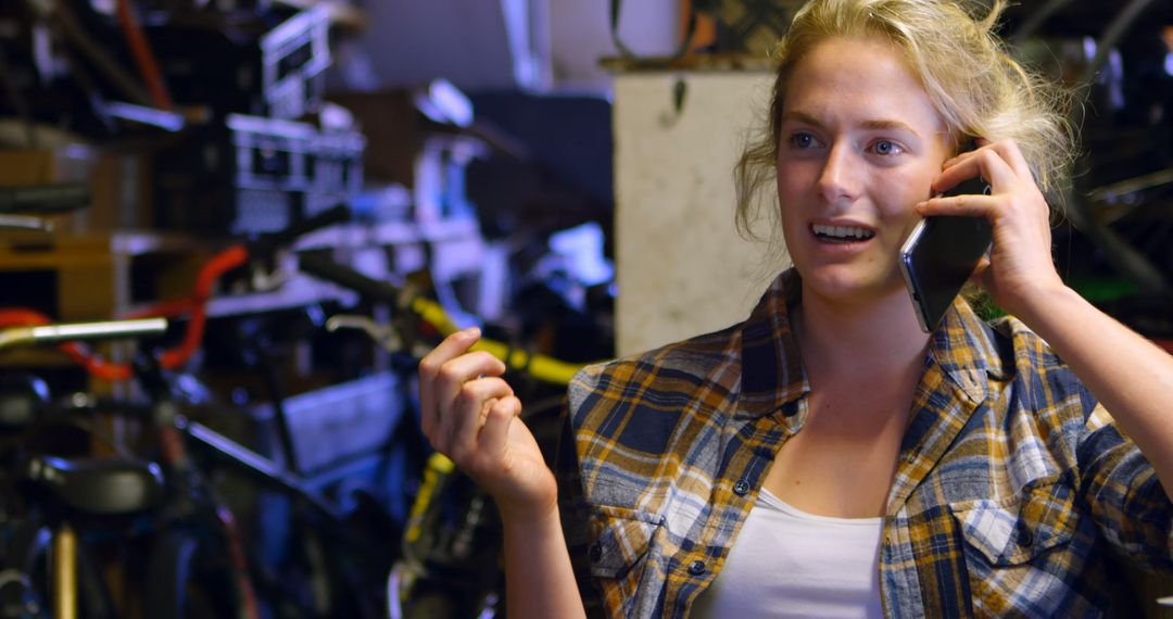 Woman Engaging in Phone Call in Workshop Setting