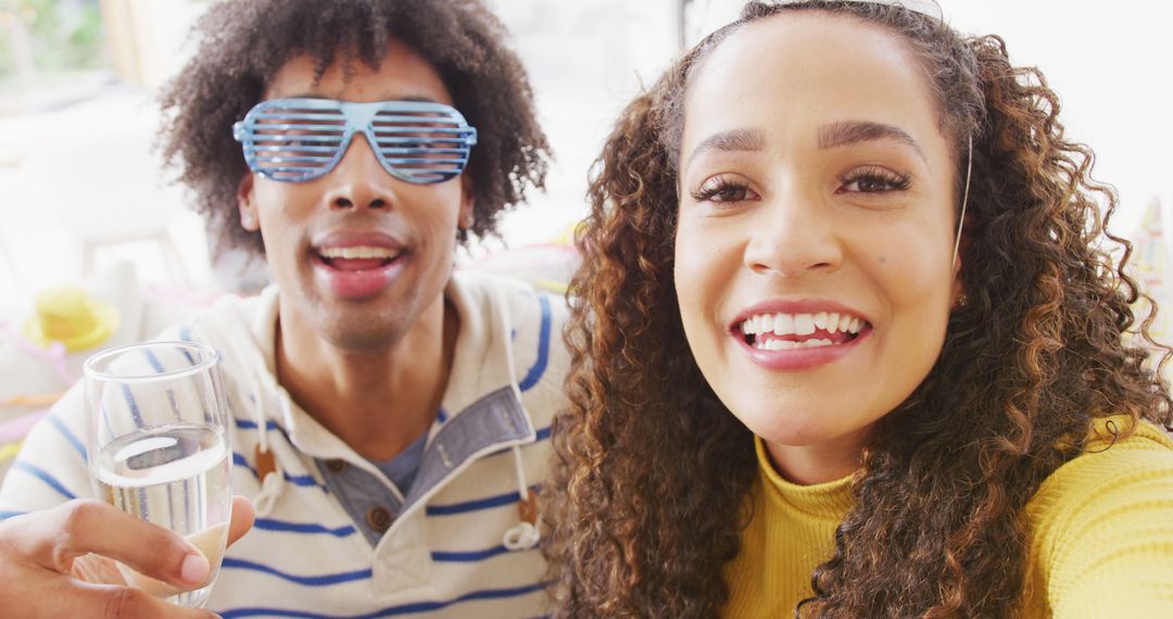 Diverse Couple Celebrating with a Video Call and Drinks