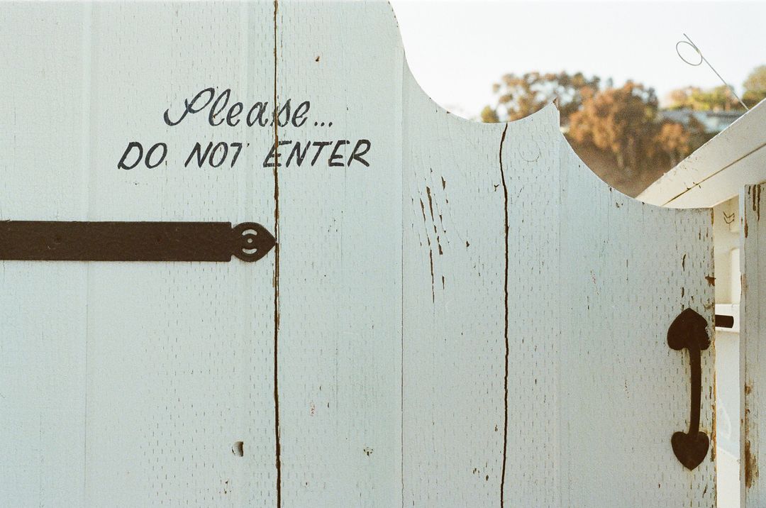 Rustic White Gate With 'Do Not Enter' Sign