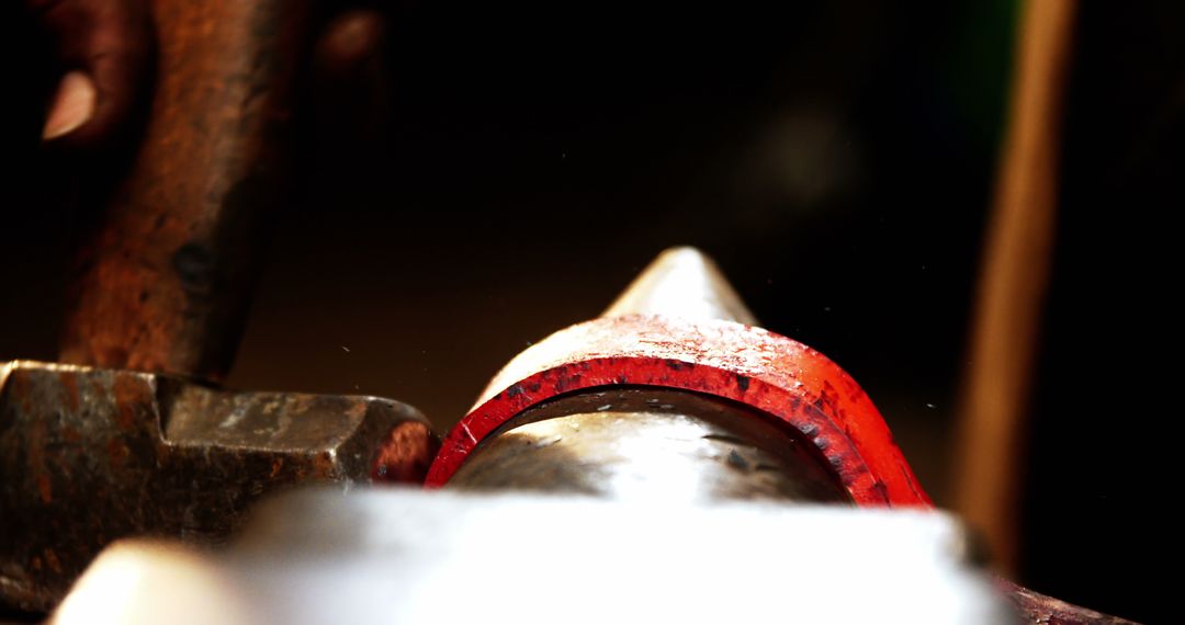 Close-Up of Blacksmith Hammering Red-Hot Iron in Workshop