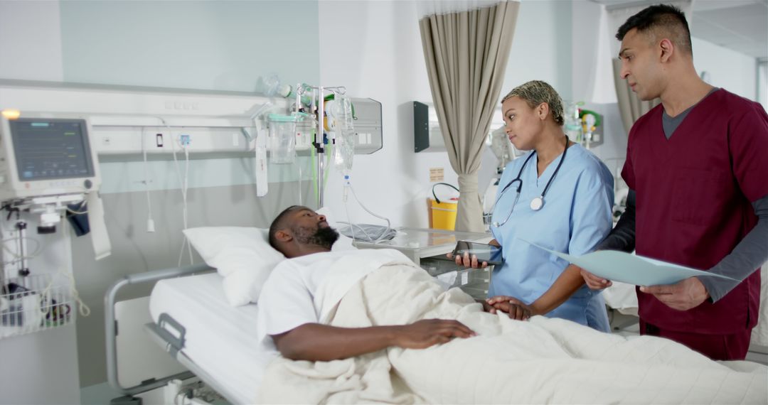 Medical Professionals Attending to Patient in Hospital Bed - Free Images, Stock Photos and Pictures on Pikwizard.com