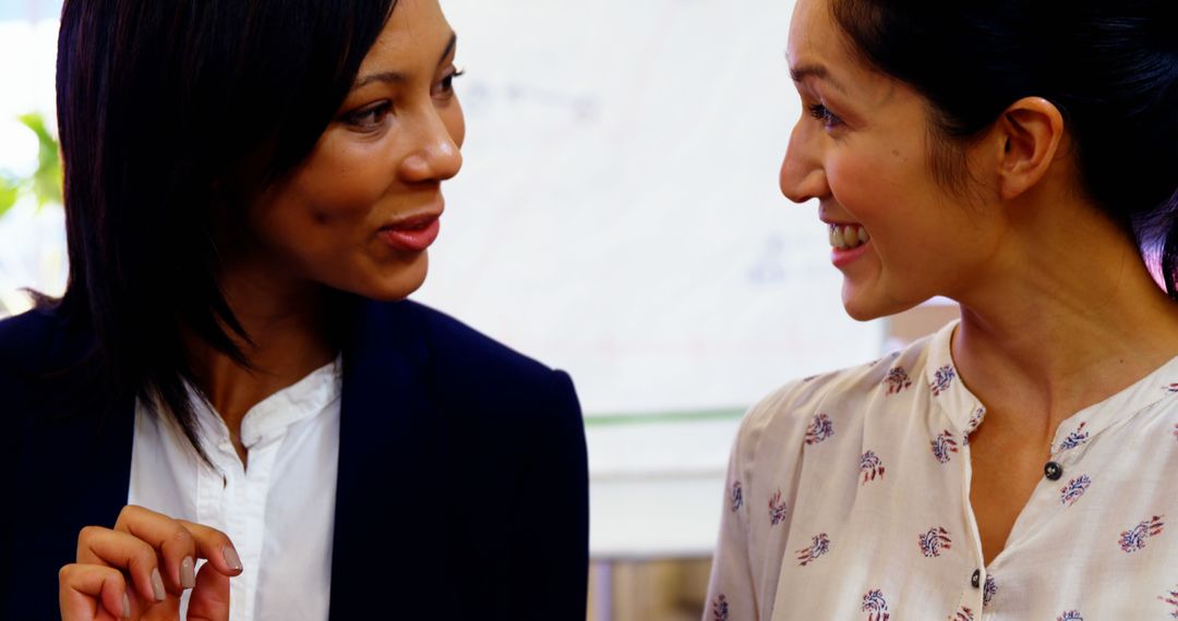 Multiracial Businesswomen Having Friendly Conversation in Office - Free Images, Stock Photos and Pictures on Pikwizard.com