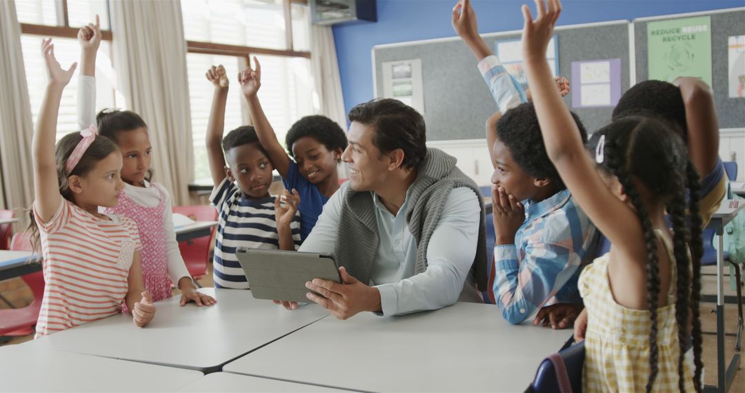 Teacher Using Digital Tablet in Classroom with Enthusiastic Schoolchildren - Free Images, Stock Photos and Pictures on Pikwizard.com