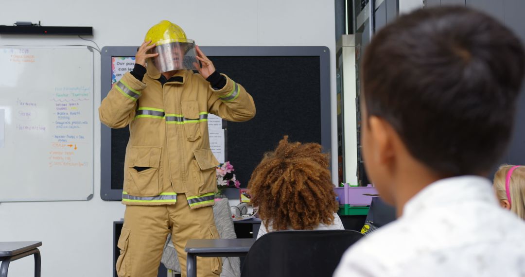 Firefighter Demonstrating Safety Techniques to Attentive Schoolchildren