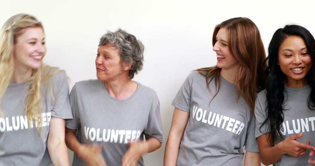 Cheerful Volunteers in Gray T-Shirts Smiling and Energized - Free Images, Stock Photos and Pictures on Pikwizard.com