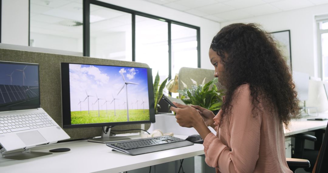 Woman in Office with Sustainable Energy Display on Screen