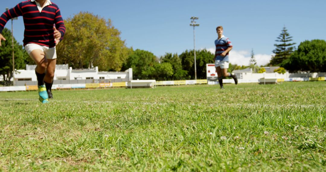 Young Rugby Players Practicing on Sunny Field - Free Images, Stock Photos and Pictures on Pikwizard.com