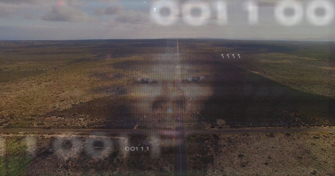 Futuristic Holographic Face Over Desert with Binary Code