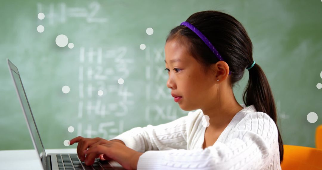 Asian Student Engaged with Laptop in Classroom Setting