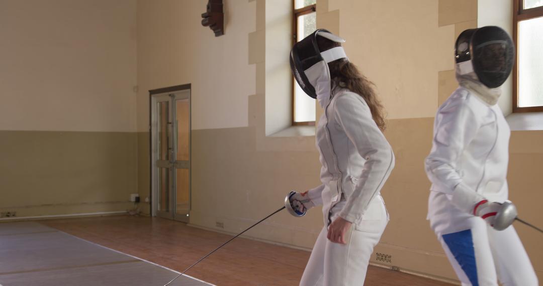 Female Fencers Preparing to Duel in Gymnasium - Free Images, Stock Photos and Pictures on Pikwizard.com