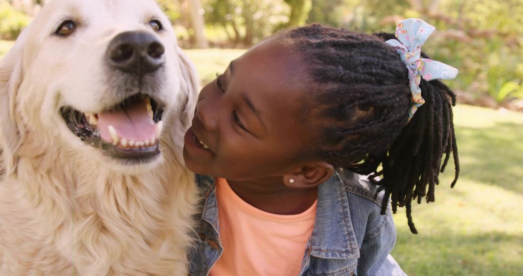 Joyful Child Bonding with Golden Retriever in Sunny Park