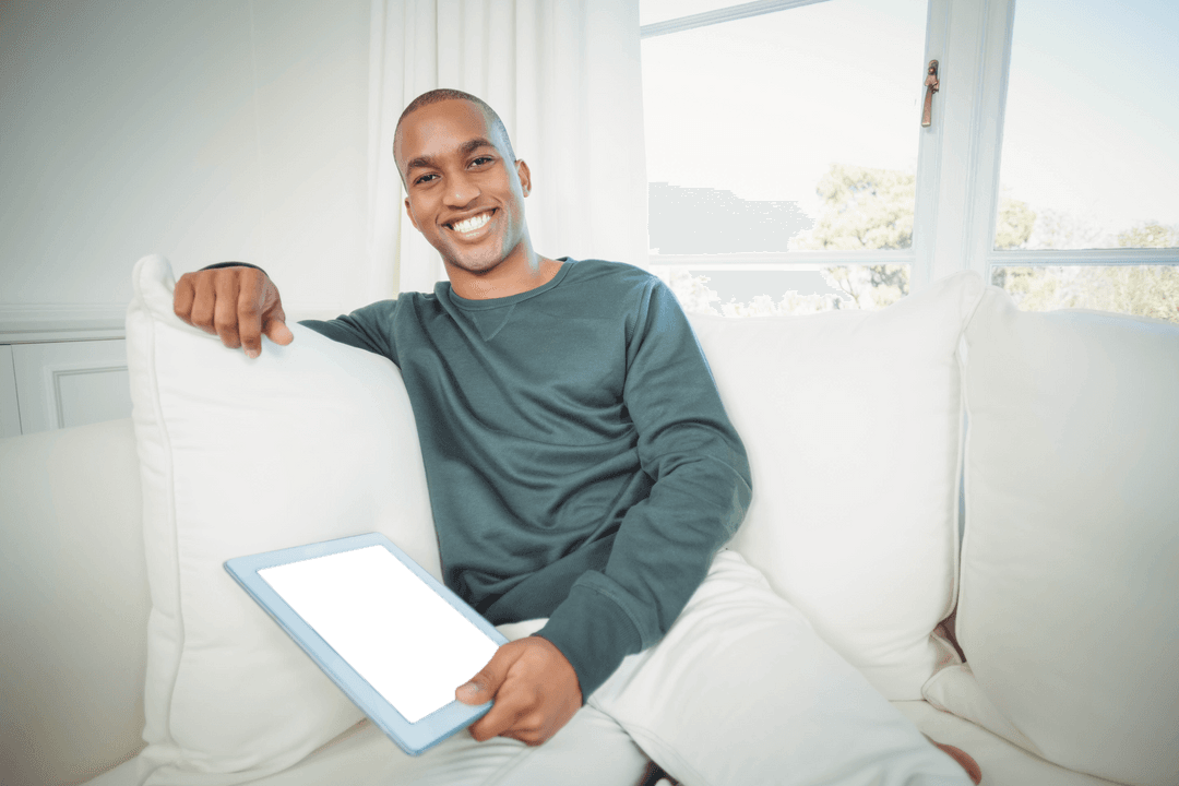 Transparent Background: Smiling Man with Tablet on Sofa at Home