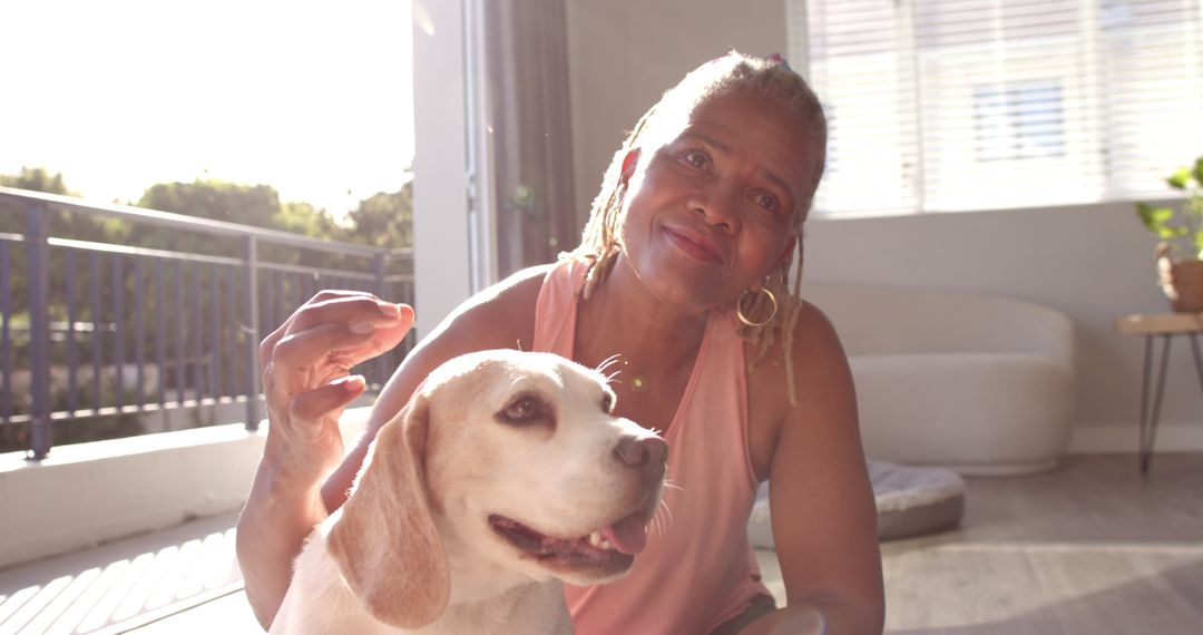 Senior Woman Relaxing with Her Beagle at Home in Natural Light