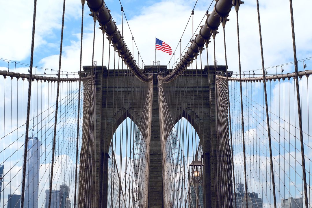Iconic Brooklyn Bridge with American Flag on Clear Day - Free Images, Stock Photos and Pictures on Pikwizard.com