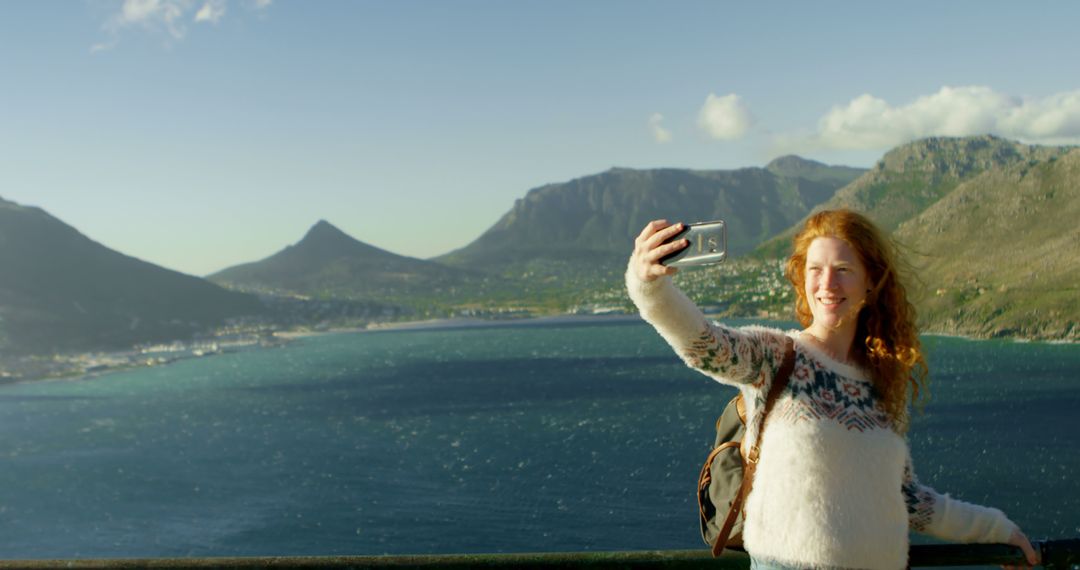 Young Woman Taking Selfie with Scenic Mountain View - Free Images, Stock Photos and Pictures on Pikwizard.com