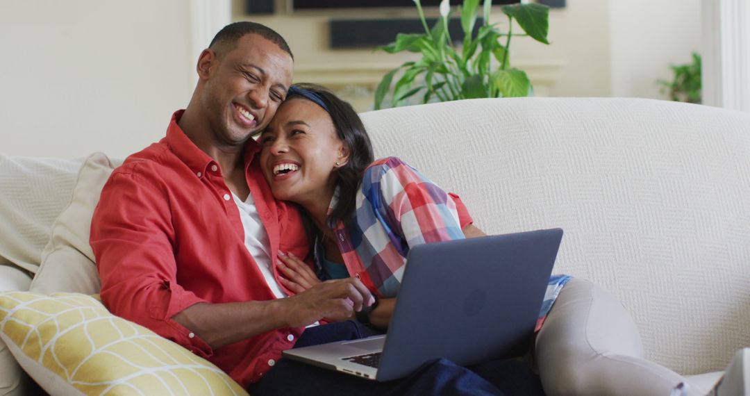 Loving Mixed Race Couple Relaxing Embracing While Using Laptop