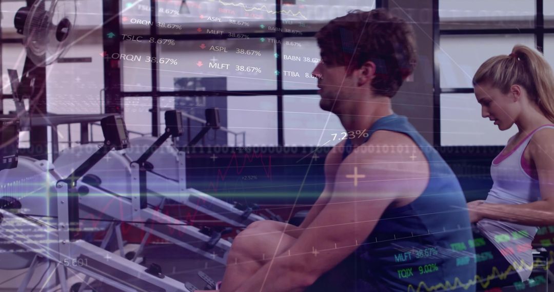 Muscular man rowing on ergometer with female partner, digital analytics overlay for cardio training