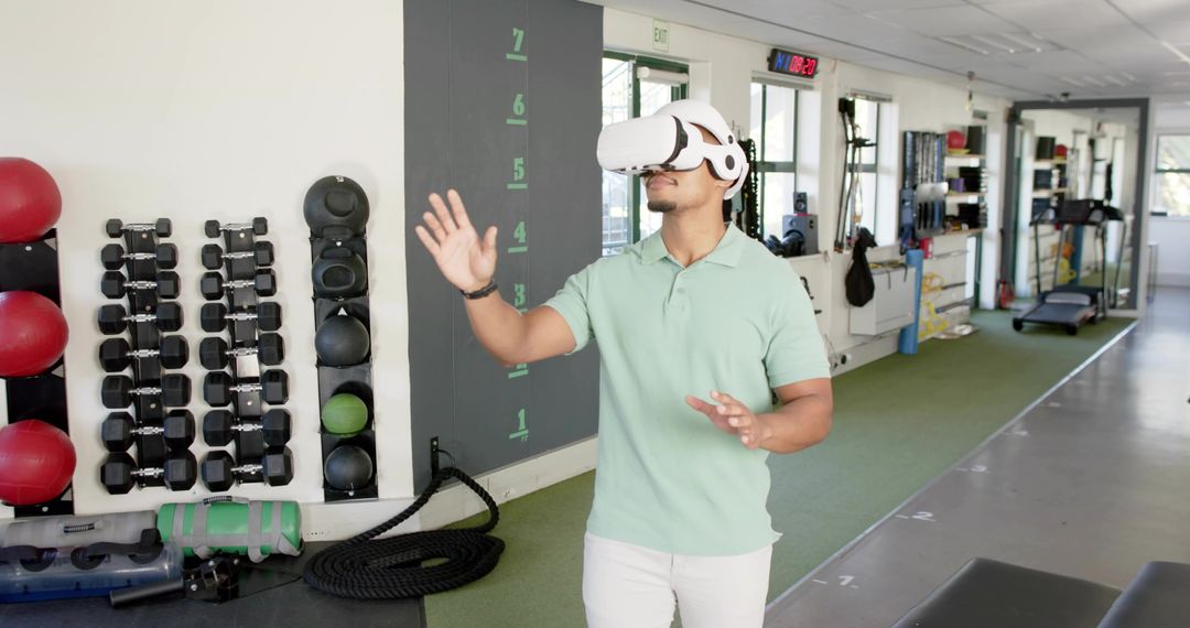 Man training with VR headset in gym using immersive fitness technology for workouts