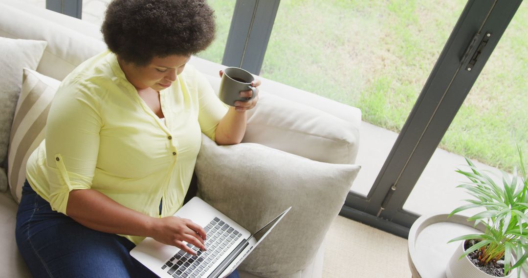 Woman Enjoys Coffee While Working on Laptop at Home - Free Images, Stock Photos and Pictures on Pikwizard.com