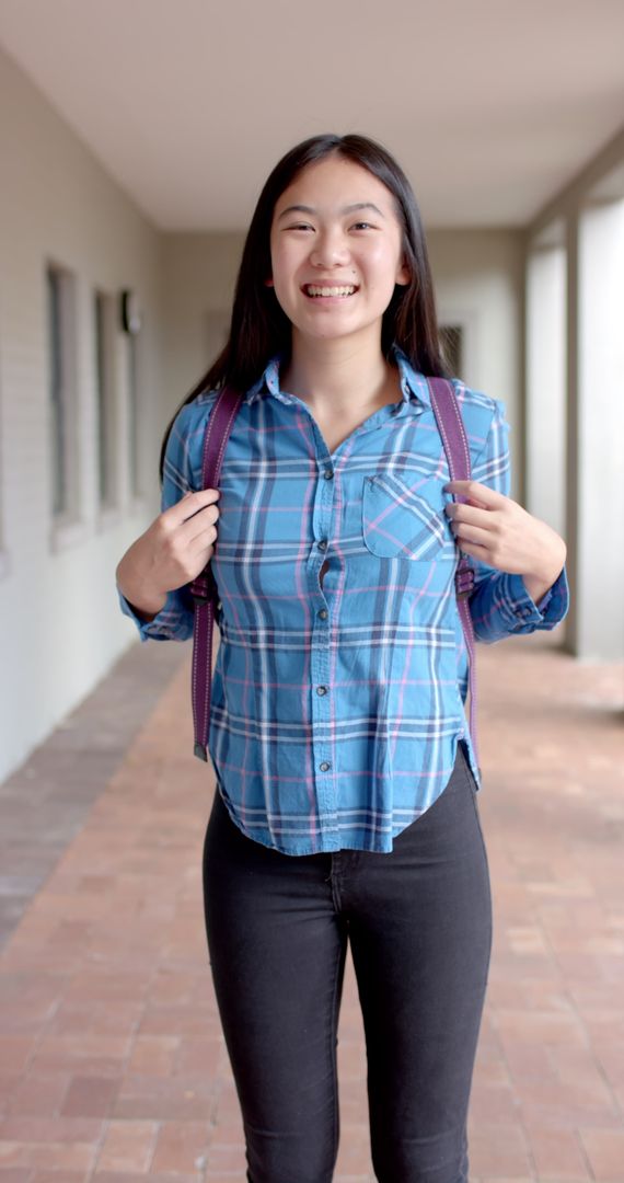 Happy Student Embracing High School Life with Backpack
