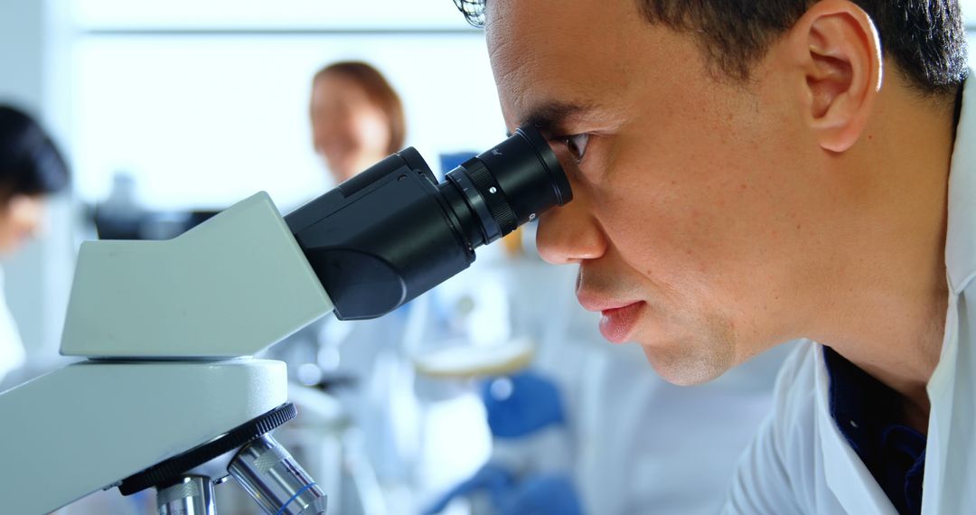 Scientist Examining Sample Under Microscope in Laboratory - Free Images, Stock Photos and Pictures on Pikwizard.com