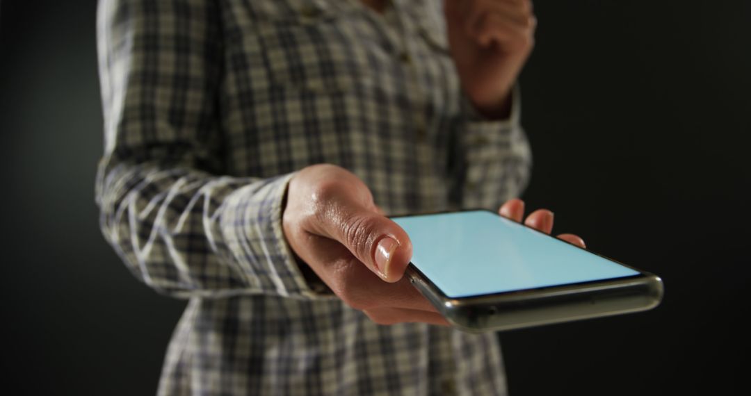 Person Handing a Smartphone With Blank Screen - Free Images, Stock Photos and Pictures on Pikwizard.com