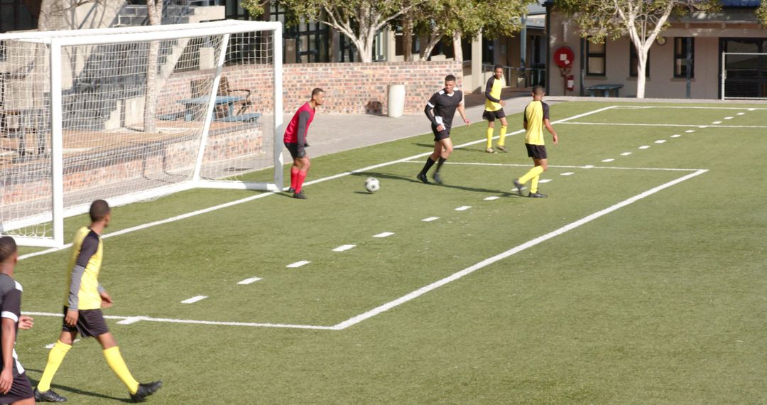Soccer Players Strategizing on Field During Match