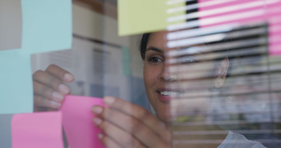 Creative Professional Organizing Sticky Notes on Glass Window in Office - Free Images, Stock Photos and Pictures on Pikwizard.com