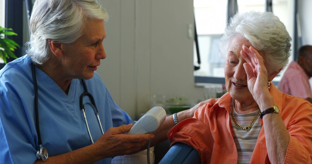 Nurse Checking Blood Pressure of Senior Woman - Free Images, Stock Photos and Pictures on Pikwizard.com