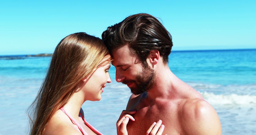 Romantic Couple Embracing on Beach with Clear Blue Sky - Free Images, Stock Photos and Pictures on Pikwizard.com