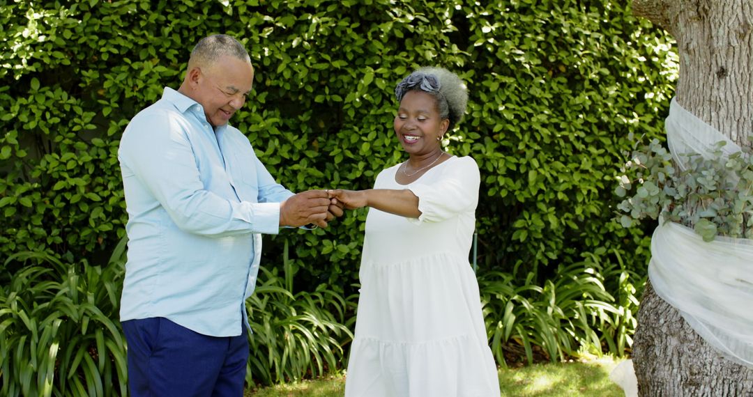 Senior Couple Exchanging Rings in Courtyard