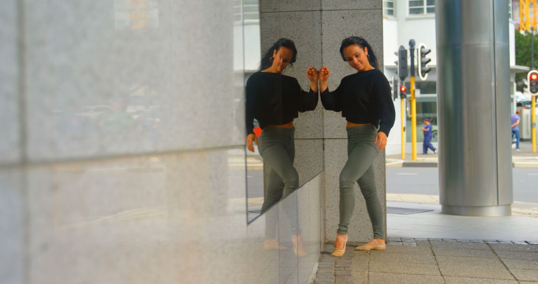 Woman Leaning Against Urban Building Reflective Surface - Free Images, Stock Photos and Pictures on Pikwizard.com