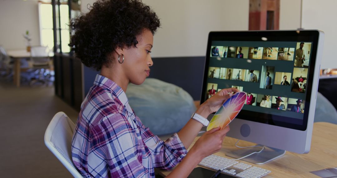 African American Designer Analyzing Color Palette in Modern Office