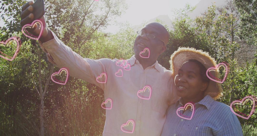 Senior African American Couple Taking Selfie with Heart Overlay Outdoors