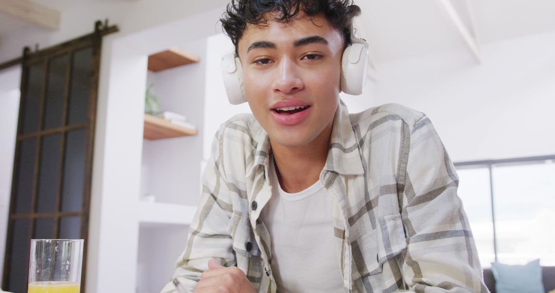 Young Man Listening to Music with Headphones at Home - Free Images, Stock Photos and Pictures on Pikwizard.com