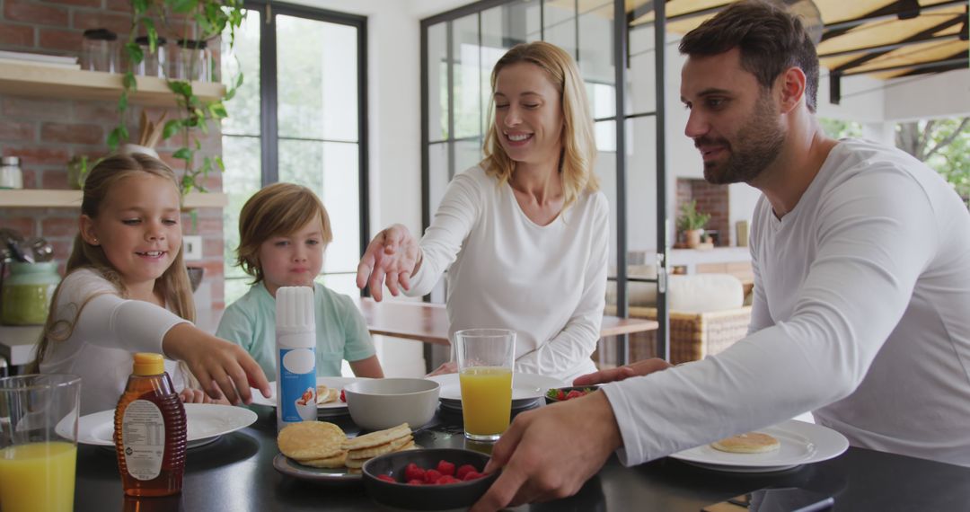 Happy Family Having Breakfast Together in Modern Home - Free Images, Stock Photos and Pictures on Pikwizard.com