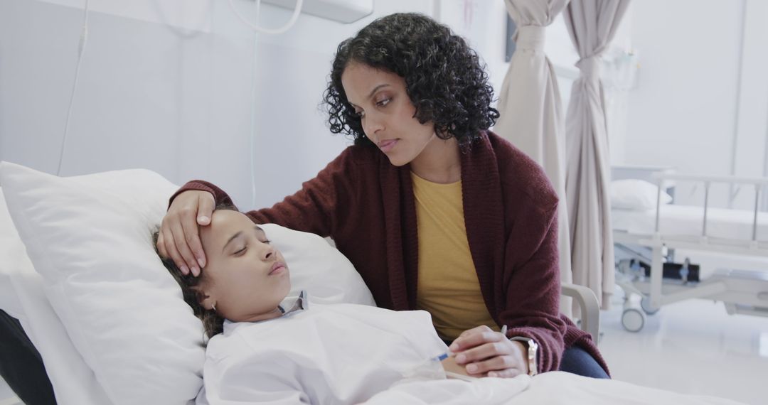 Sad biracial mother with daughter lying and sleeping in hospital bed - Free Images, Stock Photos and Pictures on Pikwizard.com