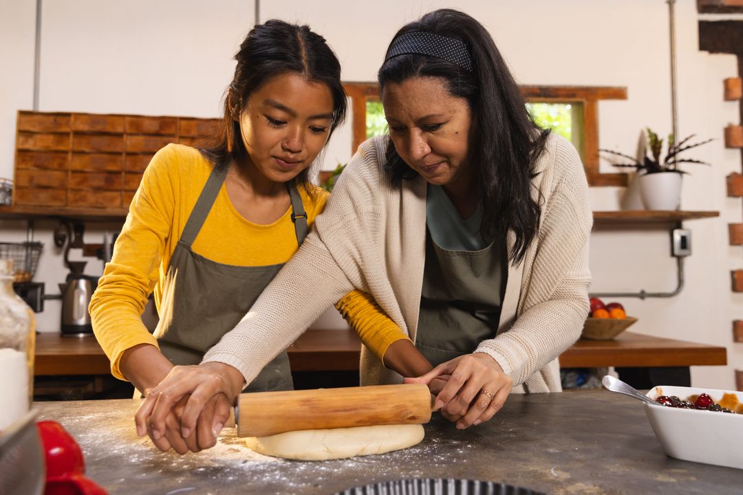 Mother and Daughter Bonding While Rolling Dough in Home Kitchen