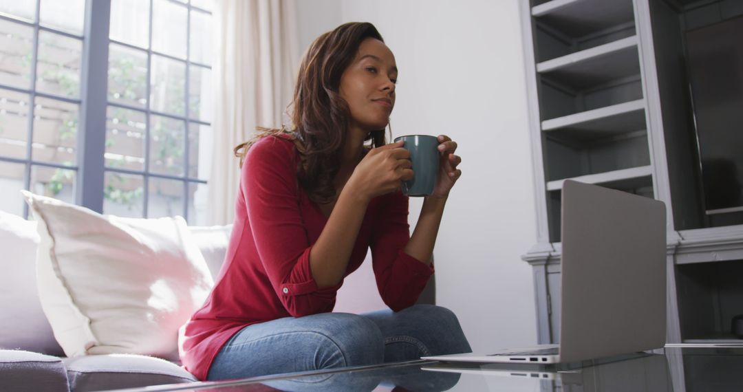 Woman Relaxing at Home with Laptop and Coffee - Free Images, Stock Photos and Pictures on Pikwizard.com