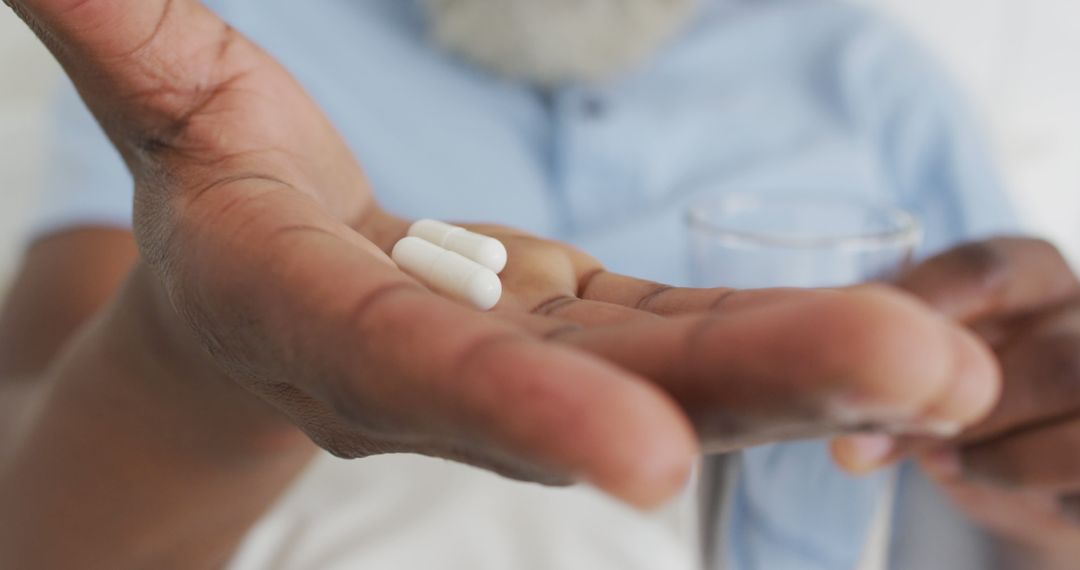 Close-Up of Person Holding Pills and Glass of Water - Free Images, Stock Photos and Pictures on Pikwizard.com