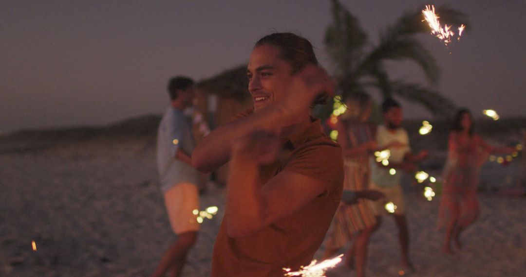 Friends Enjoying Evening Beach Party with Sparklers - Free Images, Stock Photos and Pictures on Pikwizard.com