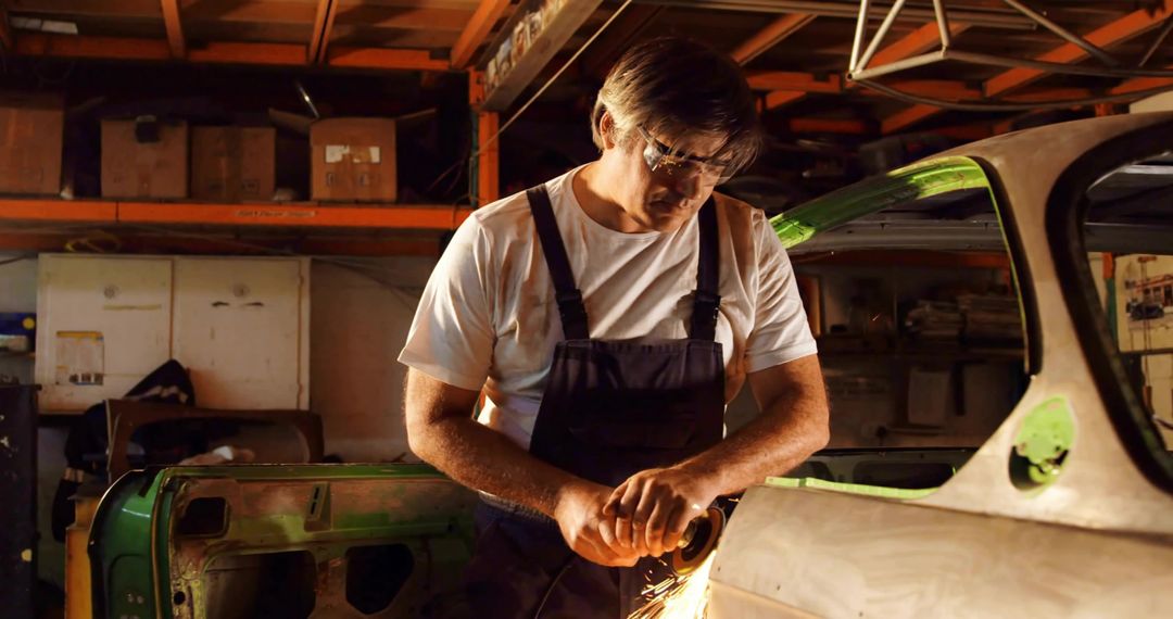 Skilled Mechanic Using Angle Grinder in Workshop Garage
