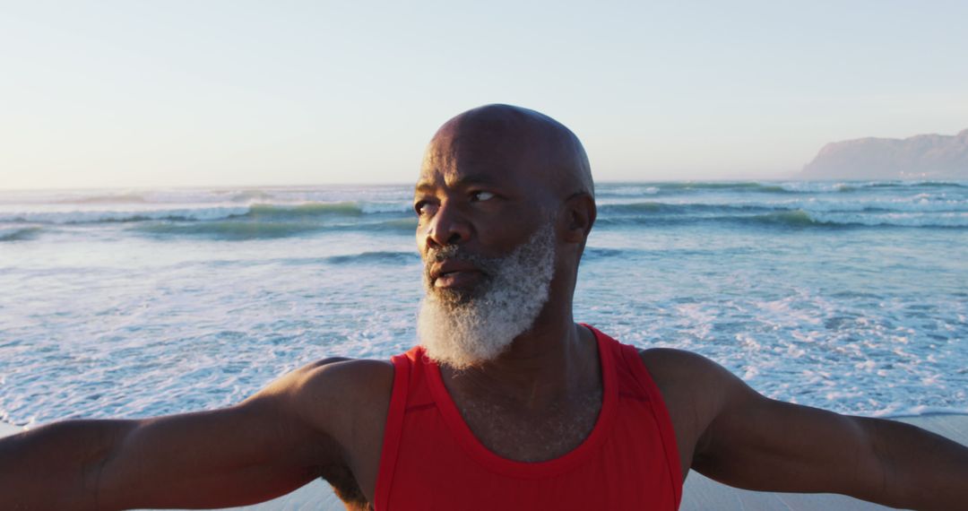 Senior Man Exercising on Beach with Arms Outstretched - Free Images, Stock Photos and Pictures on Pikwizard.com