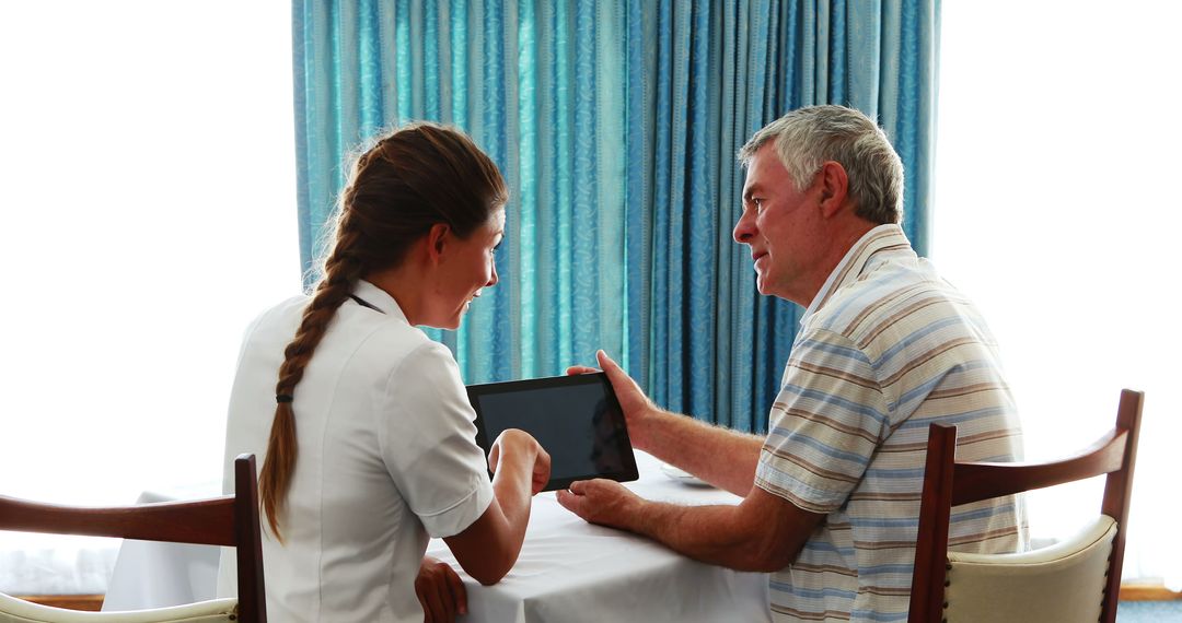 Nurse Interacting with Elderly Patient Using Tablet - Free Images, Stock Photos and Pictures on Pikwizard.com