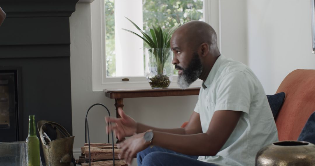 Man Seated at Table Engaging in Thoughtful Conversation