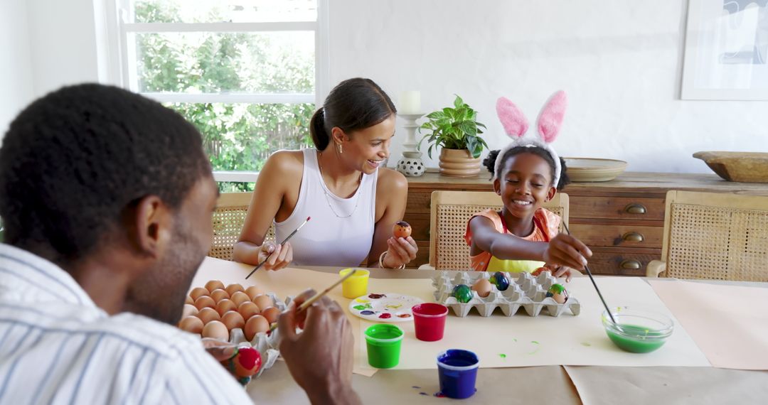 Diverse Family Painting Easter Eggs at Home