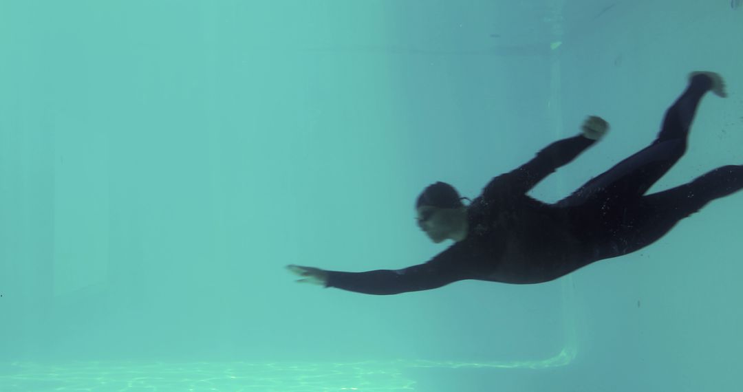 Person Swimming Underwater Creating Tranquil Aquatic Ambience